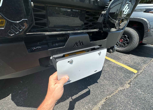 Front bumper flip up license plate bracket for Backwoods Adventure Mods Hi-Lite Series high clearance off road bumpers with hawse fairleads installed